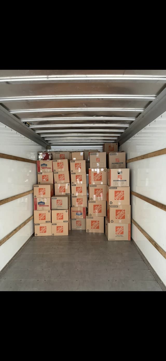 Moving truck staged with packed household boxes