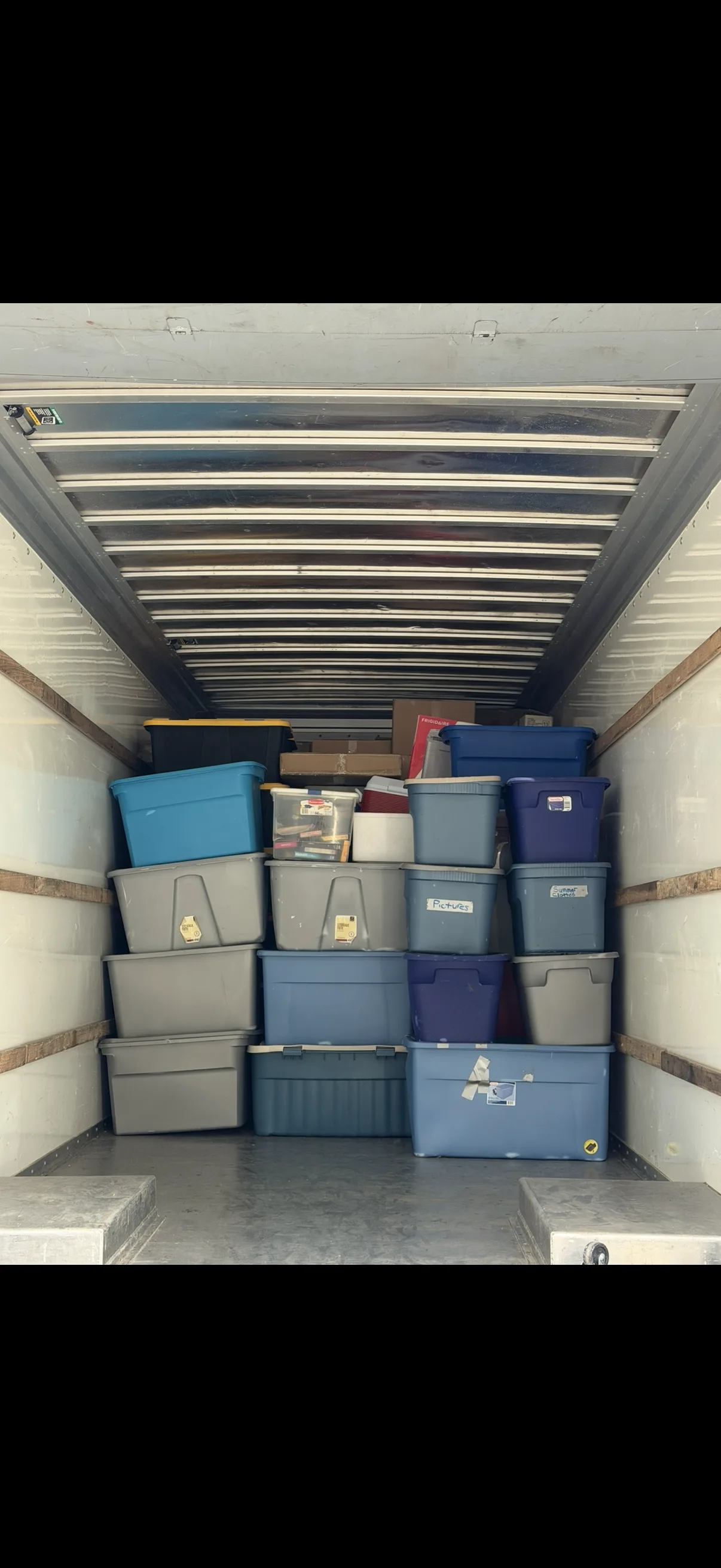 Organized truck interior with color-coded storage bins